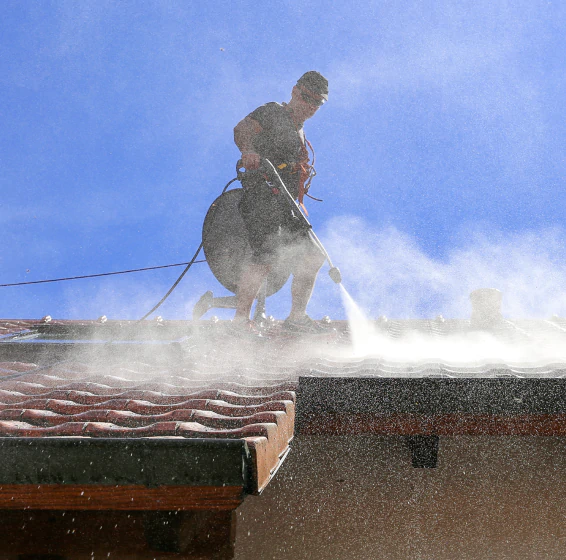 worker doing roof pressure washing service